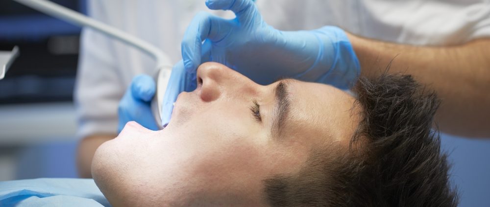 Dental Patient wit mouth open in dental chair.