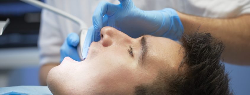 Dental Patient wit mouth open in dental chair.